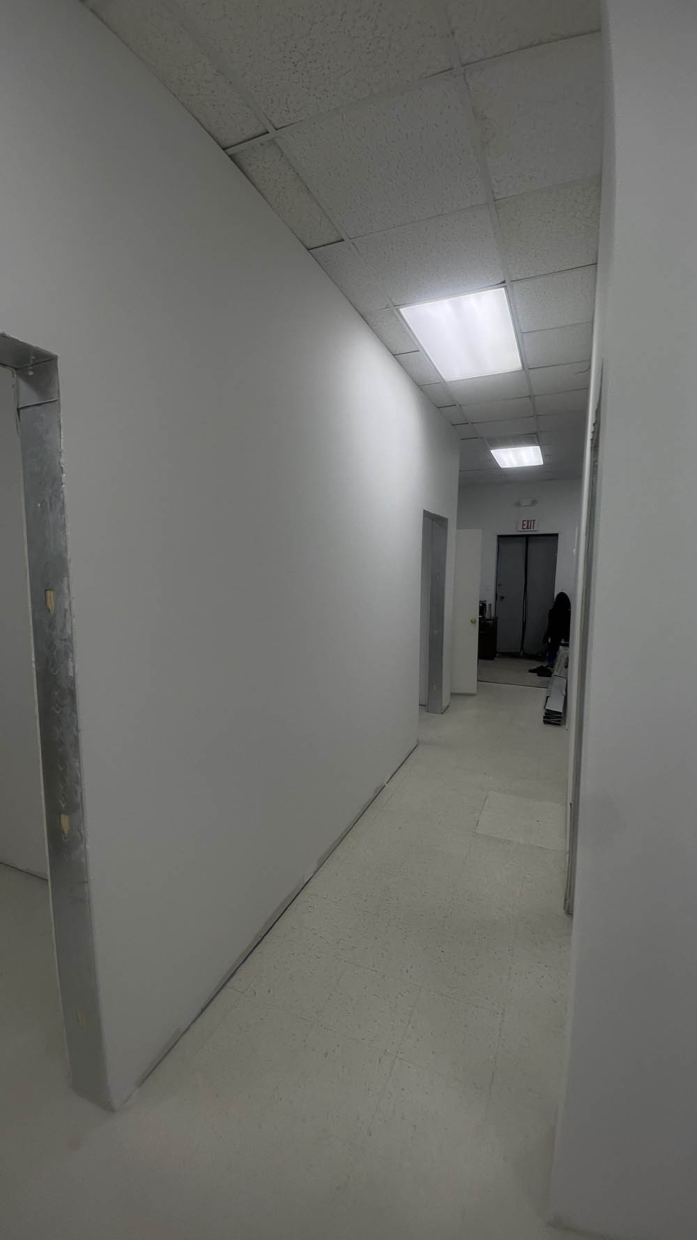 Finished commercial office corridor painted in satin with cased door openings